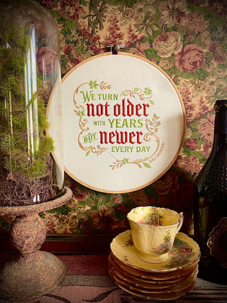 "We turn not older with years, but newer every day." Embroidered Sampler